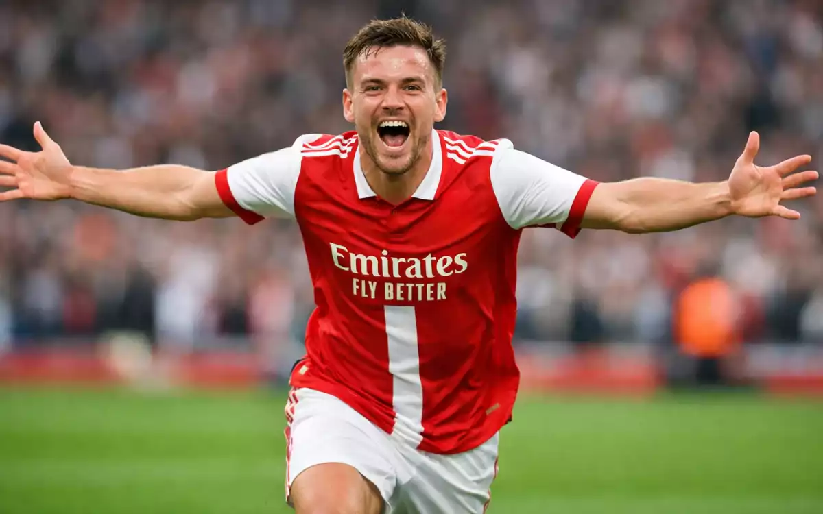Jugador de f&uacute;tbol celebrando un gol con los brazos abiertos